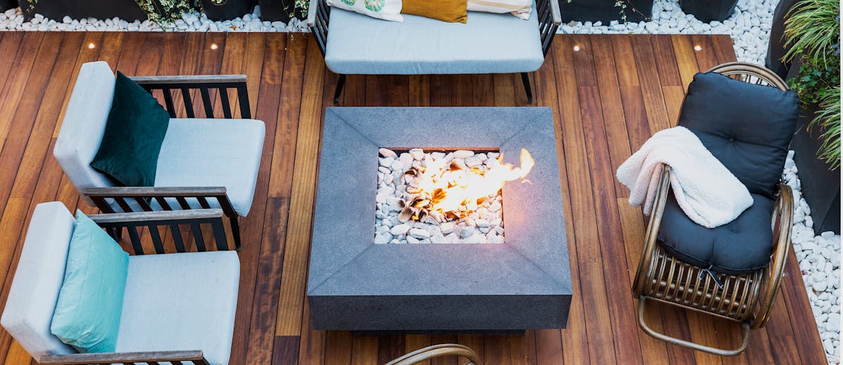 A backyard patio with a fire pit at dusk — the kind of outdoor evening mosquito control helps you enjoy again